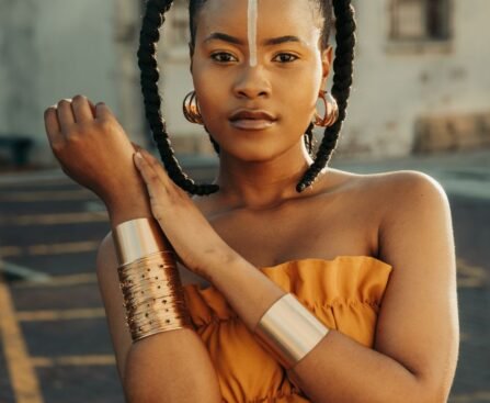stylish woman with bold jewelry in urban setting